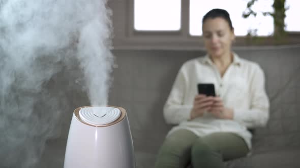 Female Relax By Aroma Diffuser in Room