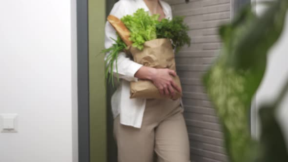 Girl Man Carries A Package Of Products Brought Home, Shopping In The Supermarket, No Paper Bag