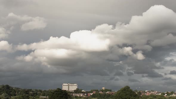 Fast paced timelapse with a dominating cloudy sky filled with cumulus clouds. Possible nimbus clouds