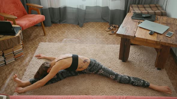 Woman Does Stretching Twine at Home