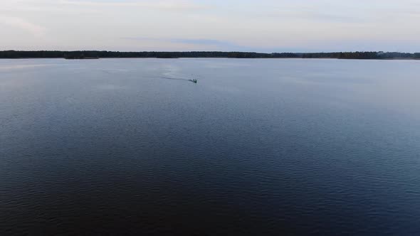 People Sail in Boat on Cold River and Enjoy Cool Summer Day