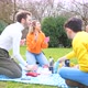 Four young students multi ethnic friends outdoor doing pic nic in a park - VideoHive Item for Sale