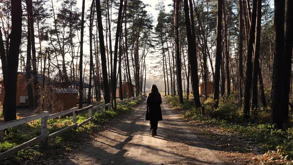 A woman walks in the woods