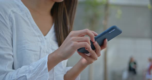 Woman use of mobile phone in city