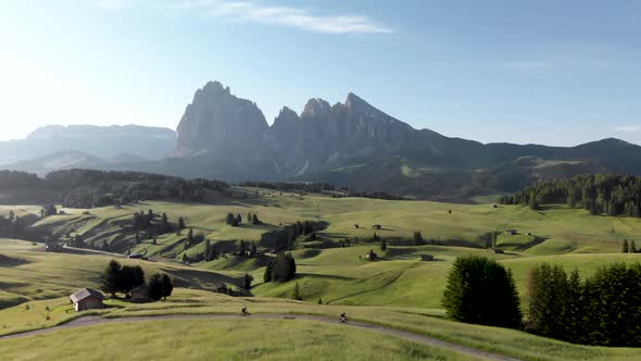 Cyclists Riding Bicycles at Seiser Alm Meadows in Dolomites Italy