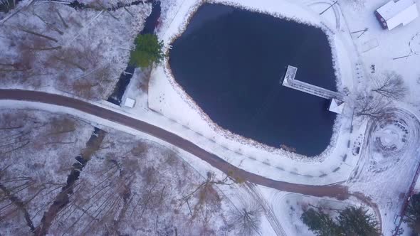 Small Frozen Pond in Winter Forest