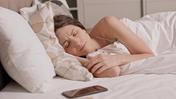 Smartphone Alarm Waking up Happy Woman