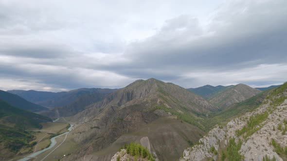 FPV Sport Drone Shot Above Dive Fast Movement Near Natural Cliff Texture to River Wild Landscape