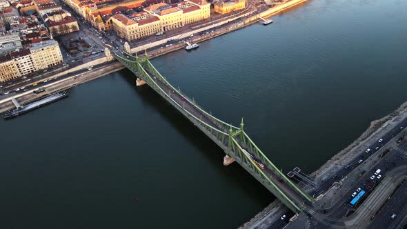 Tram passing across Liberty bridge in Budapest Hungary with Danube river view ,4K aerial topdown dro