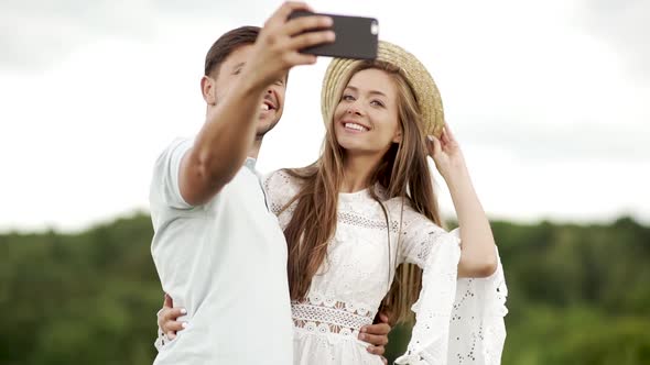 Romantic Happy Couple In Love Taking Photos On Phone In Nature.