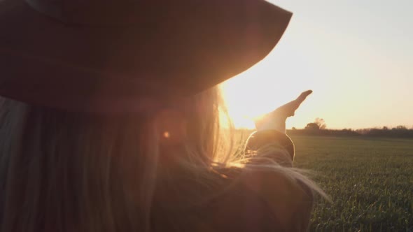 Girl Looks at the Sun Through Her Hand