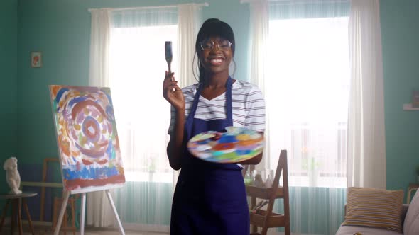 Portrait of Black Woman Artist Having Fun in Studio