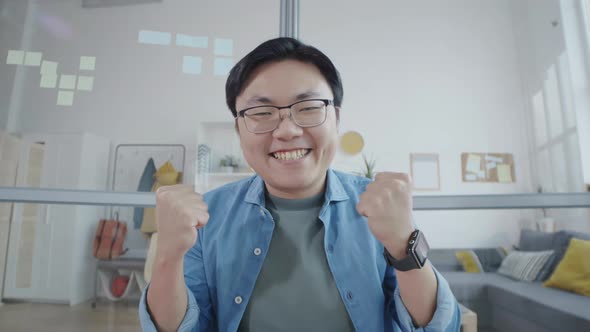 Joyous Asian Office Worker Speaking via Web Call