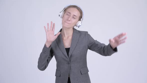 Happy Young Blonde Businesswoman Dancing and Listening To Music