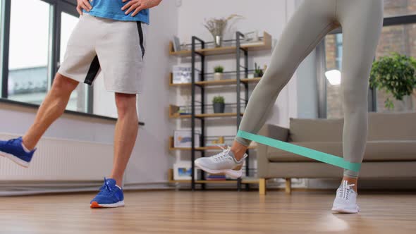 Couple Exercising with Resistance Bands at Home