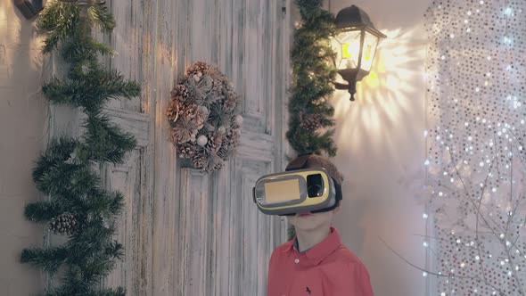 Child in Red Shirt with Yellow VR Glasses Gestures Near Door