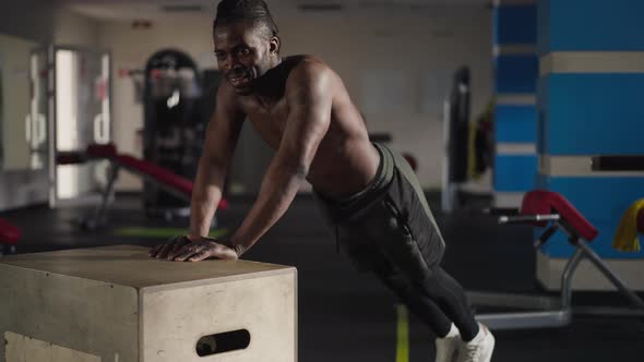 Strong Handsome African American Man Doing Pushups on Gym Cube Wide Shot