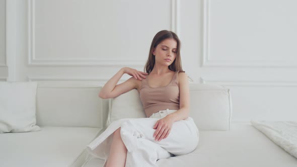 Beautiful Portrait of Young Girl in the Living Room on the Couch