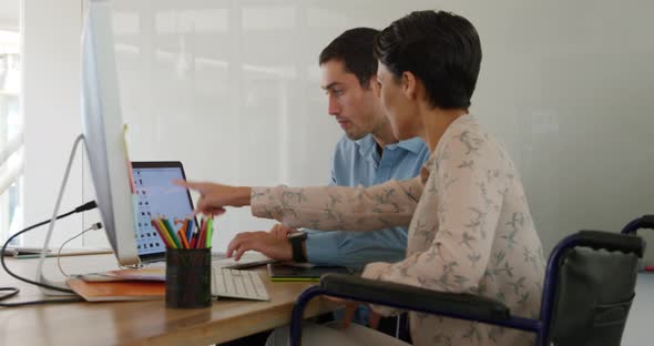 Young man and woman working in a creative office