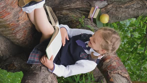 Schoolgirl Enjoying Reading Funny Story