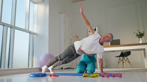 A Мan Performs Back Exercises Which Restore Physical Functions