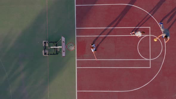 Aerial View. Family Playing Basketball on Court Outdoors