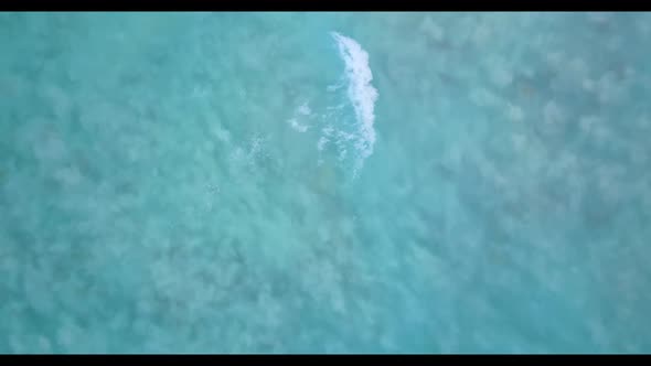 Aerial drone shot seascape of tranquil lagoon beach journey by turquoise lagoon with white sandy bac