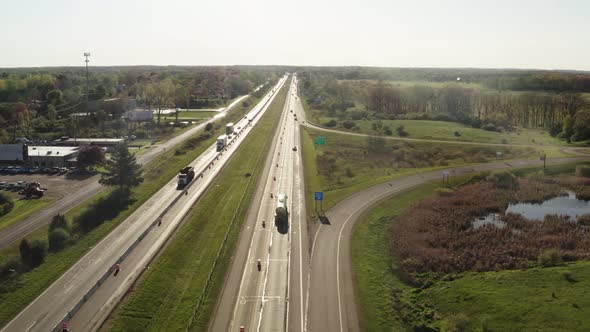 Aerial Drone Voew of Road Traffic is on Highway Amount Green Meadow Fork of the Route Main and Exits