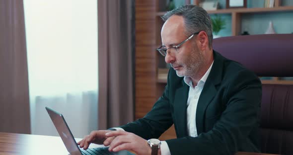 Middle Age Male Ceo Executive Manager in Suit Working at Laptop