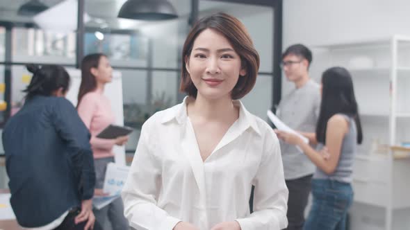 Businesswoman smart casual looking at camera and smile, Young Asia lady standing in meeting room