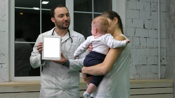 Doctor Showing Mother and Her Kid Medical Results on The