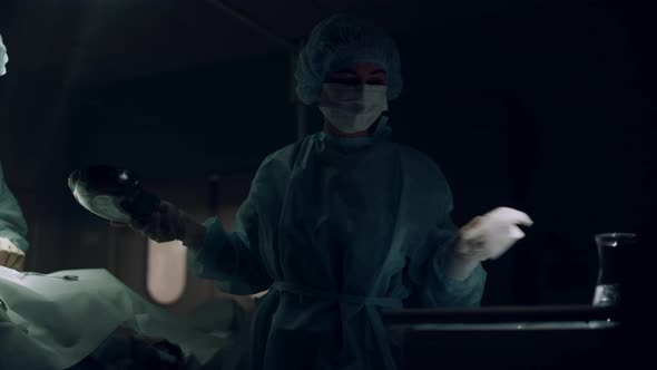 Professional Surgeon Operating in Dark Emergency Room