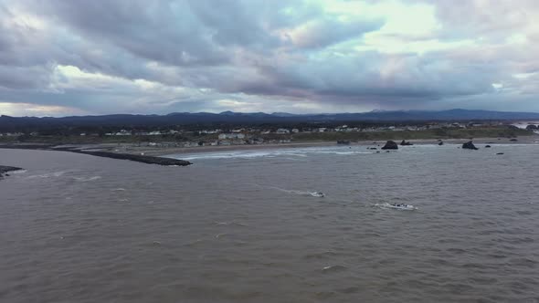 Fishing boats going out to sea in Bandon by the Sea, Oregon Coast. Aerial view.