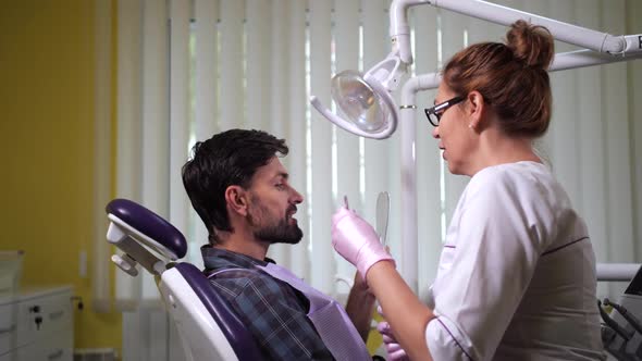 Patient Looking in Mirror After Dental Treatment