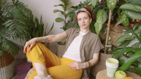 Attractive Redhead Woman Posing for Camera in Indoor Home Garden