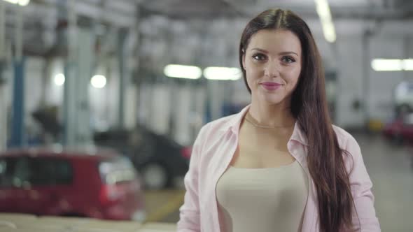 Portrait of Confident Caucasian Car Dealer Looking at Camera and Smiling