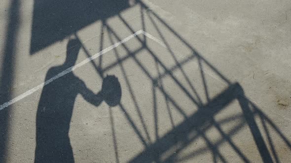 Shadow of sportsman dribbling a ball and shooting it through the basket, career