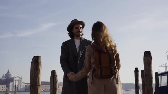 Slow motion shot of young couple on a pier in Venice