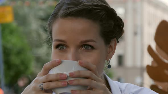 Young Beautiful Woman Holding Cup Of Coffee At Bar