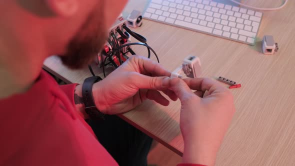 Close Up of a Robotics Teacher Hands Online Course for His Students Using a Robot