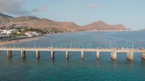 Flying parallel to a bridge on the water next to Porto Santo during the Colombo Festival.