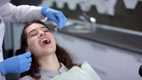 Dentist Examining Patients Teeth