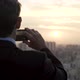 Rear view of businessman taking picture of city with smartphone - VideoHive Item for Sale
