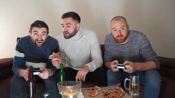 Excited Bearded Men Plays Videogame with Wireless Controllers