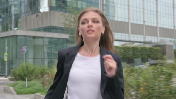 Businesswoman Running in Street in Slow Motion Front Pose