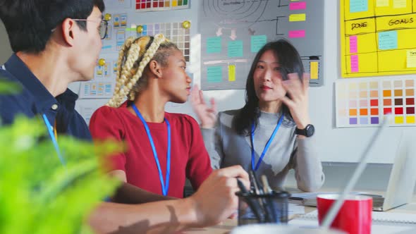 Asian staff creative senior designer coworkers consulting in office