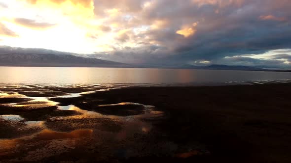 Panning aerial over water on shoreline