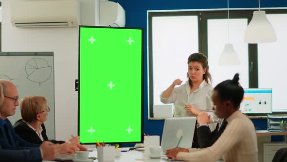 Leader Briefing Businessteam Standing in Meeting Room Showing at Greenscreen Display