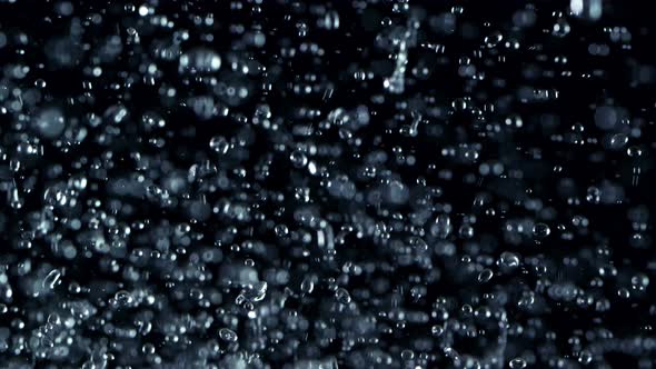 Super Slow Motion Shot Flying Water Drops Isolated on Black Background at 1000Fps