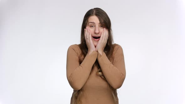 Studio Portrait of Shocked and Amazed Woman Saying Wow